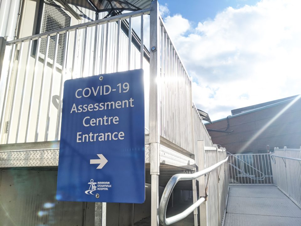 sign at directing towards the COVID-19 assessment centre entrance
