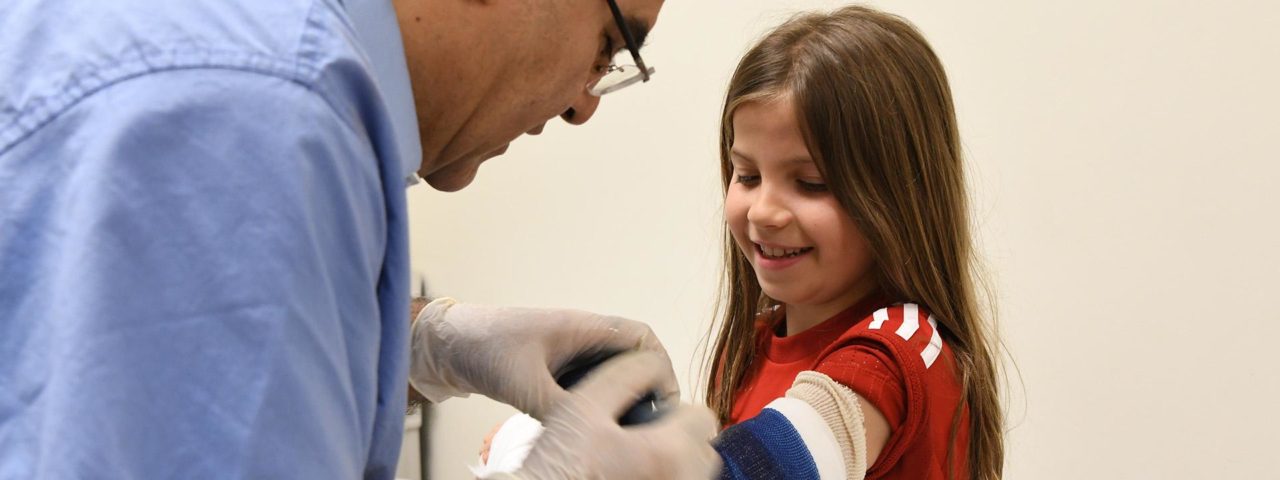 a doctor puts a bandaid on a little girl