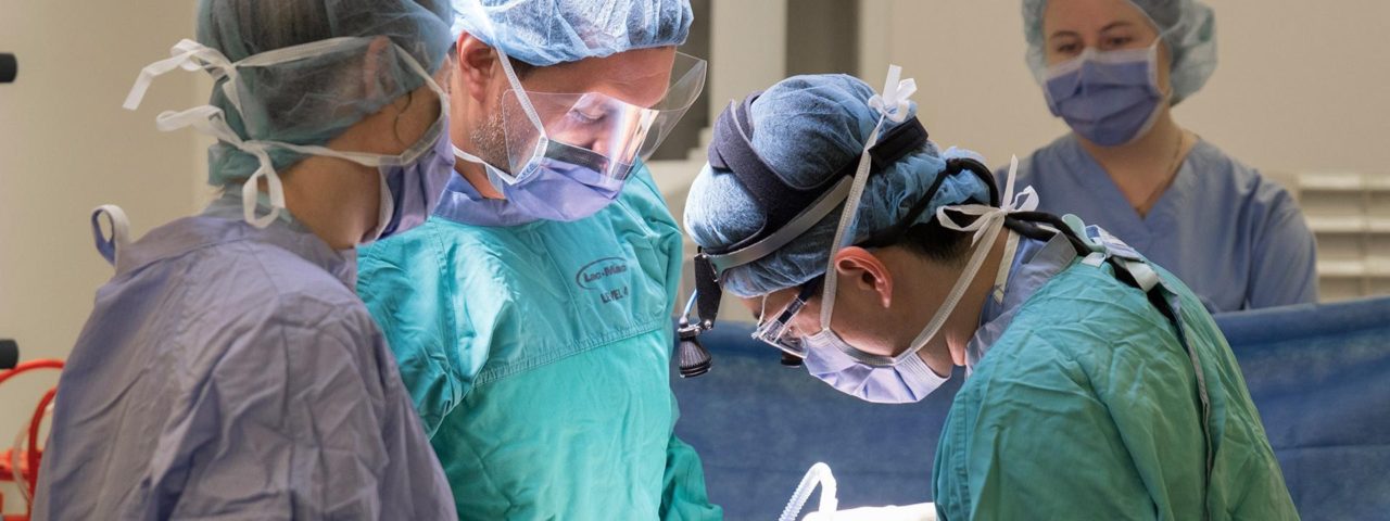 multiple doctors perform surgery