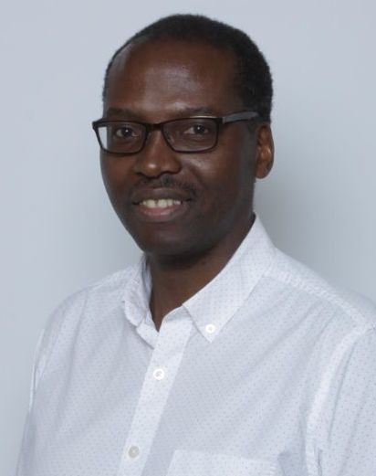 Donatus Mutasingwa seen from the waist up wearing a white shirt.