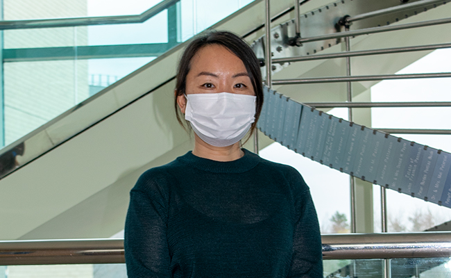 Julie Li, Interpreter, wearing a black shirt and medical mask