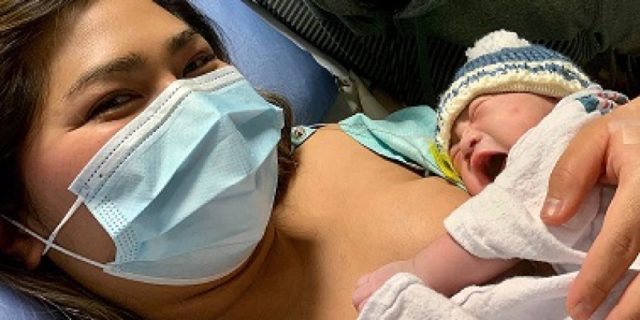 a new mom holds her newborn on her chest