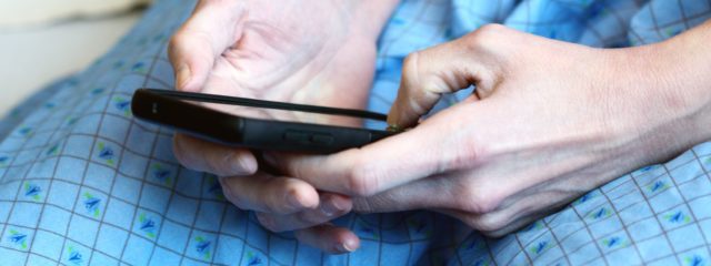 A patient looking at their mobile device