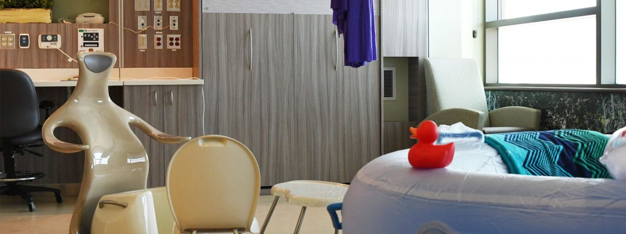 a birthing room in the midwifery unit, a tub and chair can be seen