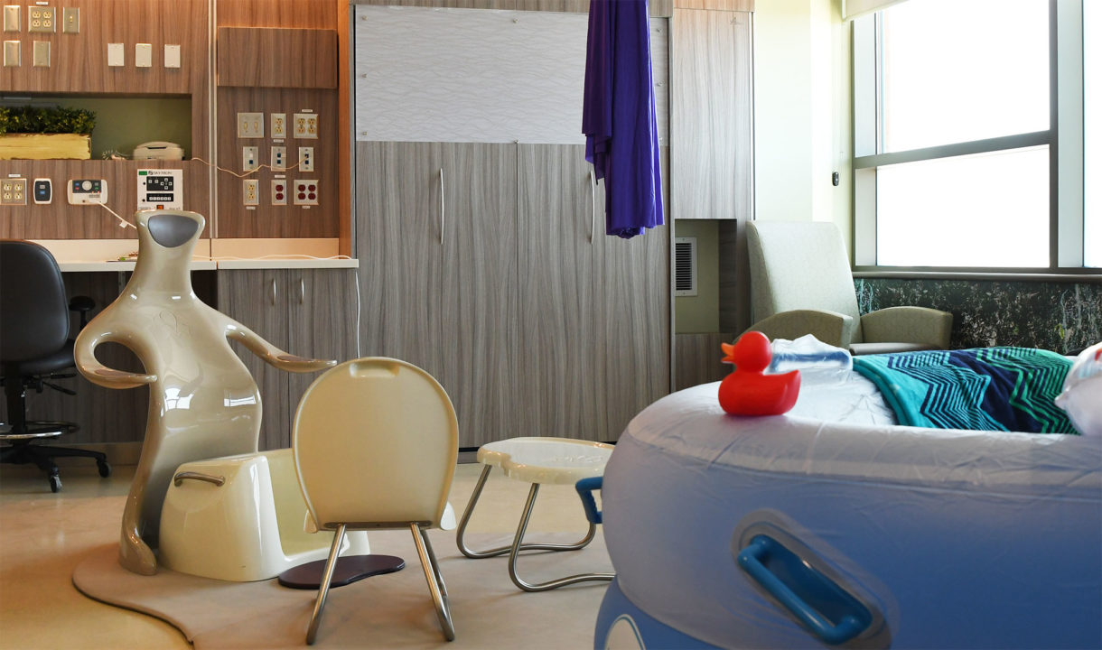 a suite in the midwifery unit. a birthing tub and chair can be seen