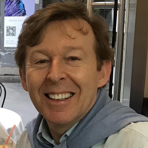 Dr. Mark Berber, seen from the shoulders up, with short brown hair and smiling