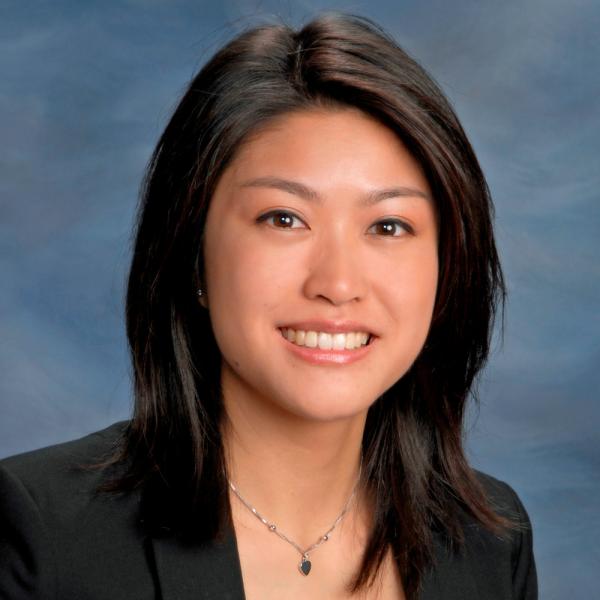 Dr. Megan Tan, seen from the shoulders up, wearing a black blazer, and shoulder length black hair