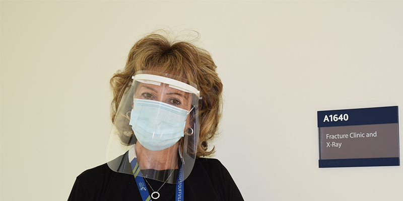 Susan Knetsch, wearing a medical mask and face shield