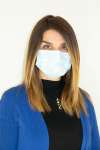 Solmaz Darvish, seen from the chest up, wearing a black shirt, blue cardigan, long brown hair, and medical mask