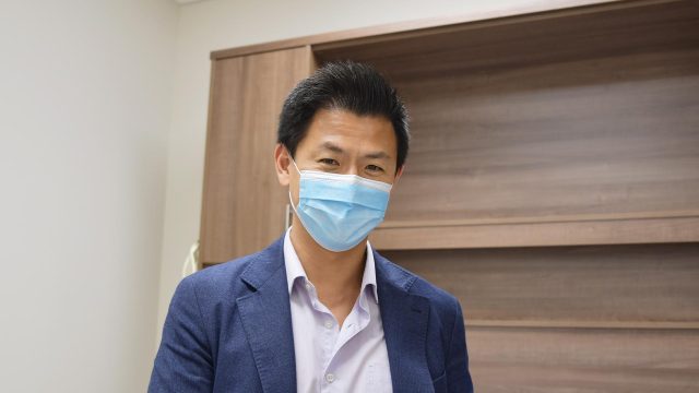 Dr. Ran (Richard) Liu shown waist up wearing a blue sport jacket and a mask.