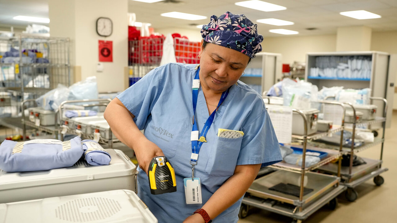A Medical Device Reprocessing staff member utilizes the new technology and scans a piece of equipment.
