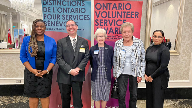 Volunteers from Oak Valley Health's Markham Stouffville Hospital stand together after being recognized for a volunteer award.